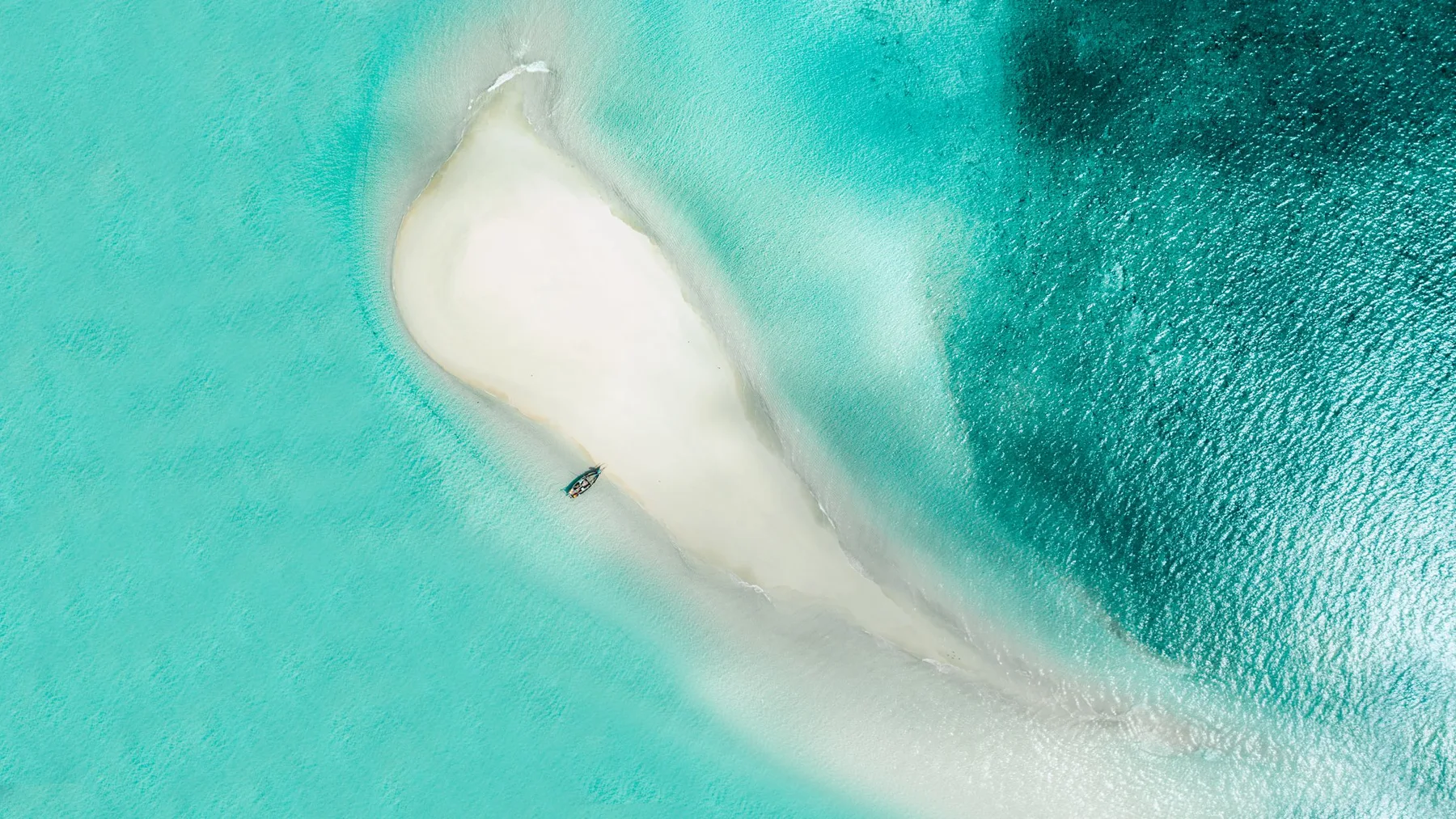 A white sandbank surrounded by turquoise water in Zanzibar