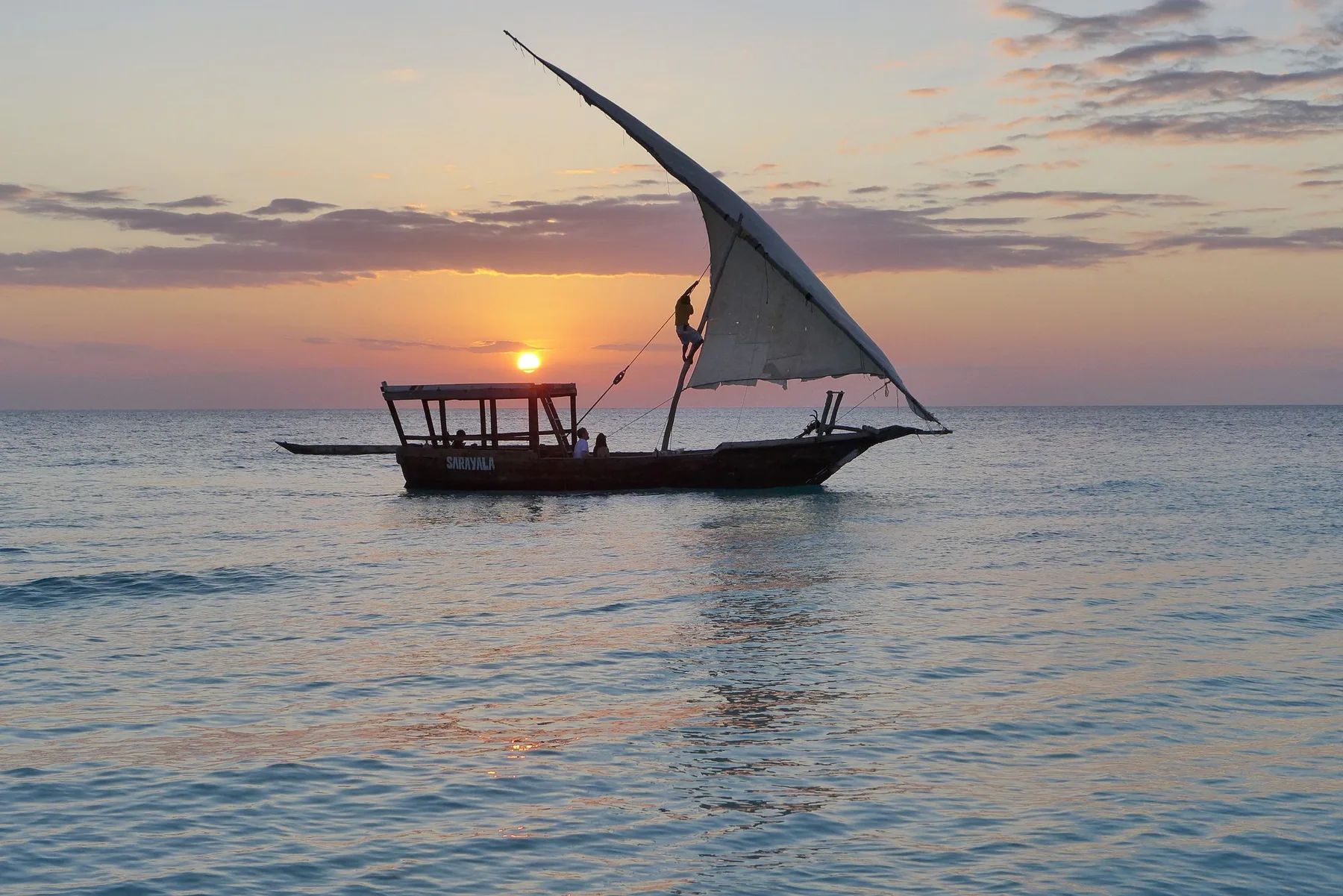 A dhow silhouetted against the sunset off Zanzibar